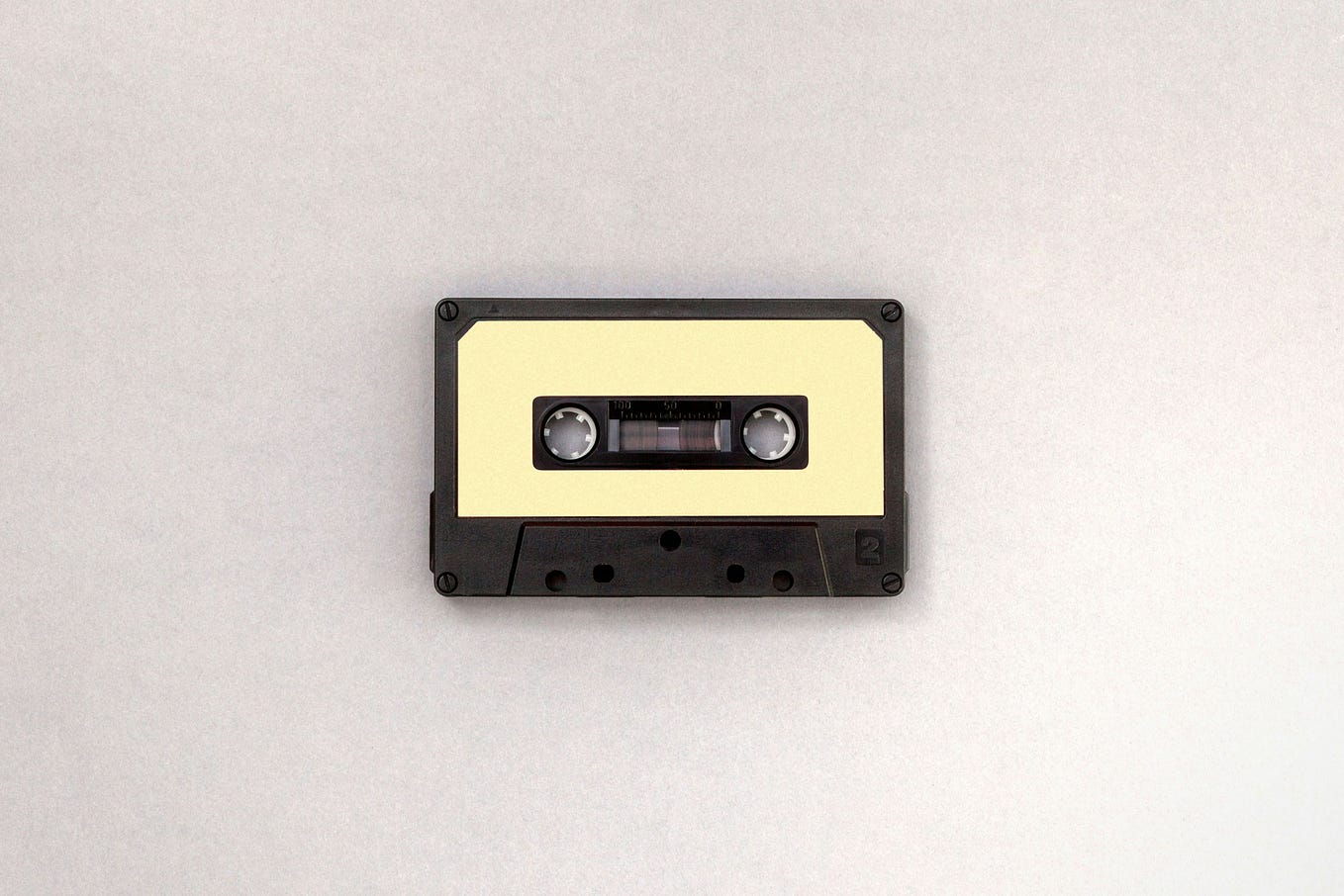 Photo of a cassette on a white background.