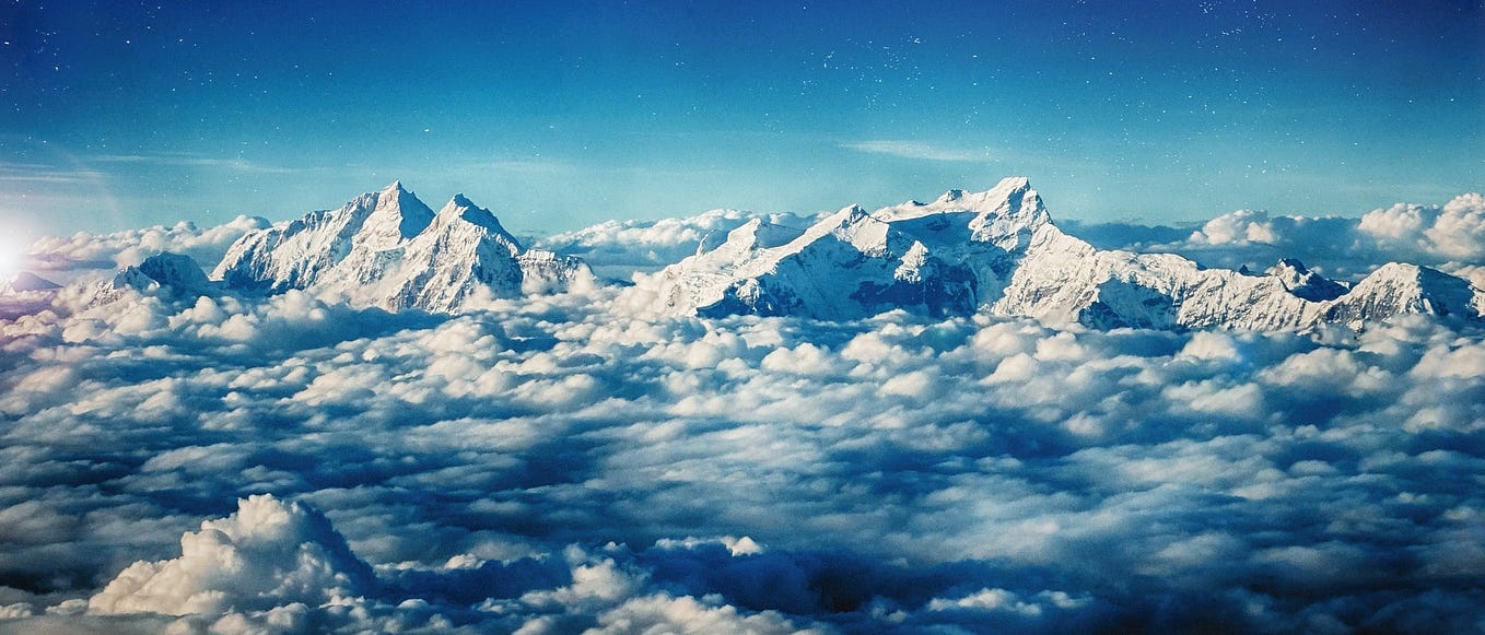 Himalayan range of mountains against a blue sky