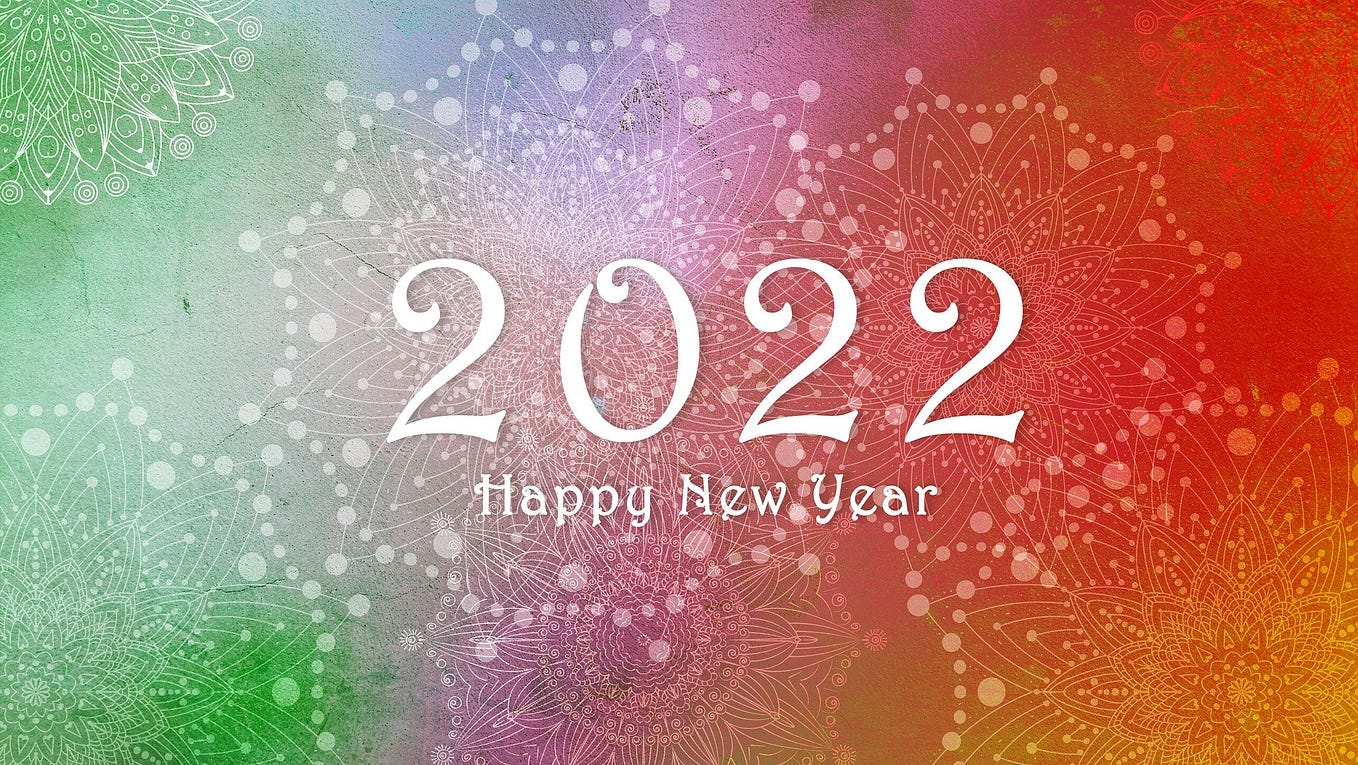 2022 Happy Ney Year on multi-color background of shooting fireworks.