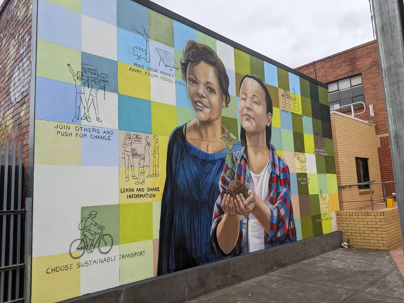 the mural reads “move your money away from fossil fuels”, “join others and push for change”, “learn and share information”, “choose sustainable transport”, “support locally grown produce”, “look out for each other”, “eat plant-based foods” and “protect nature in urban environments”