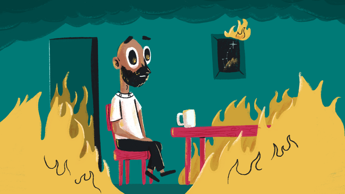 José with a blank stare, sitting in a room on fire.