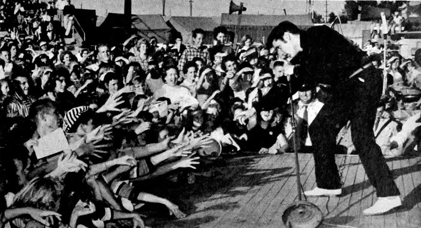 Over Labor Day Weekend, Elvis Radio released its first-ever poll of fans to pick the 100 most popular Elvis songs. Above: Elvis Presley performing live at the Mississippi-Alabama Fairgrounds in Tupelo, Mississippi, September 26, 1956. Image via Wikimedia Commons