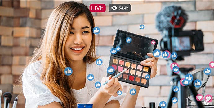 Woman giving makeup demo over a live stream as a way to market and sell products.