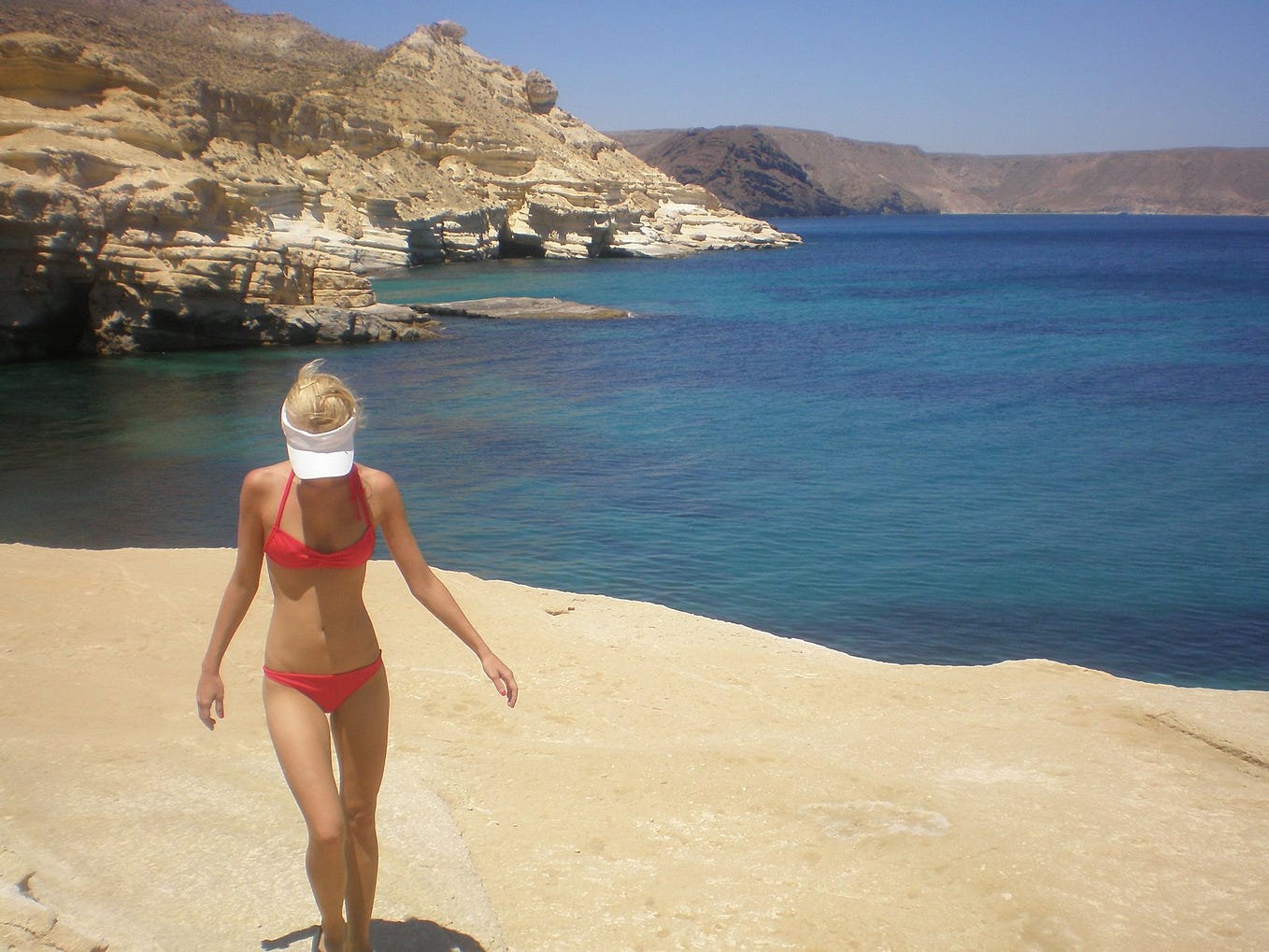 Photo of the author walking the rocky beach of Almeria, Spain.