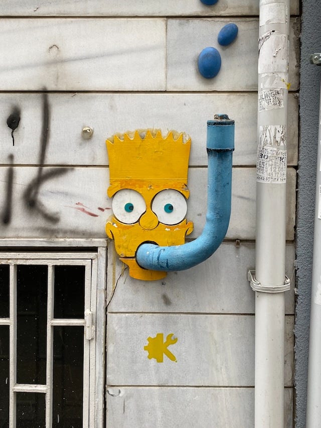 Graffiti showing Bart Simpson’s head. The exhaust pipe outside the building was turned into a snorkel.