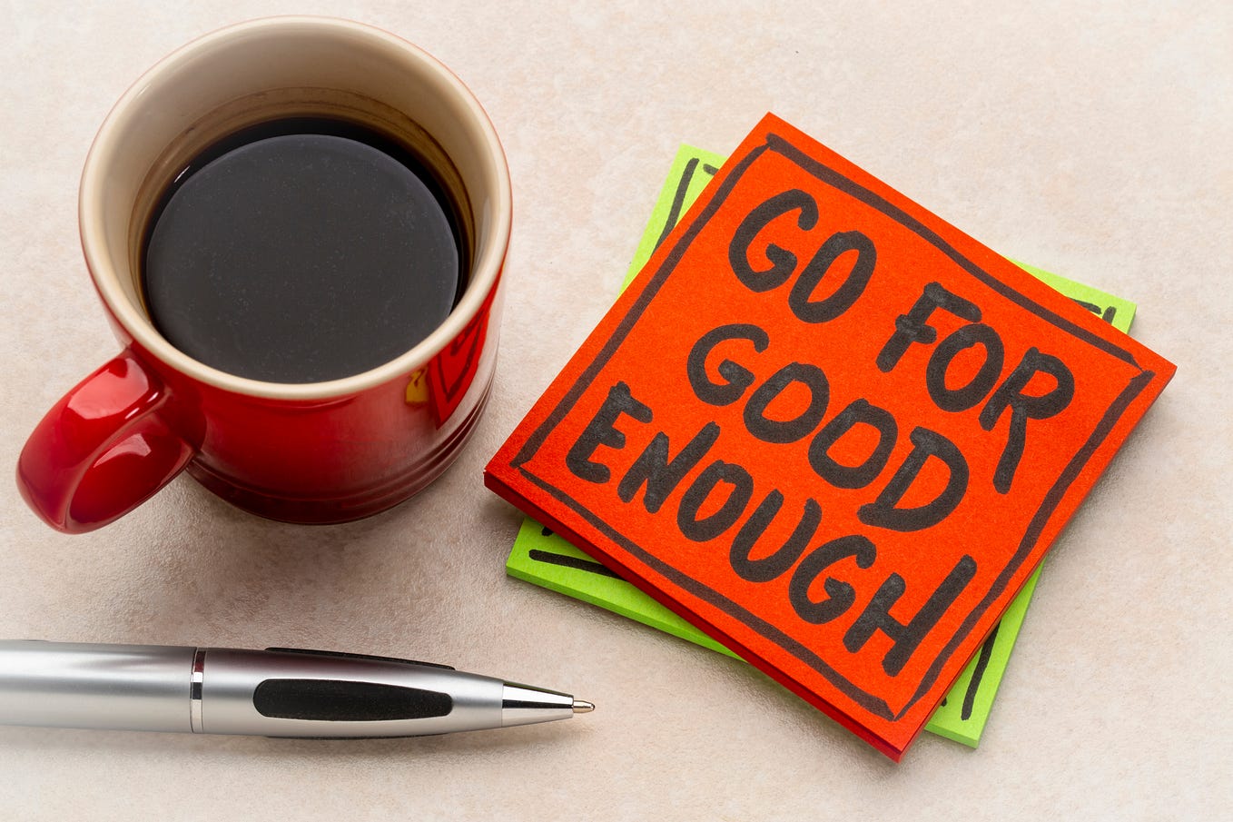 Coffee cup with note saying “Go For Good Enough”.