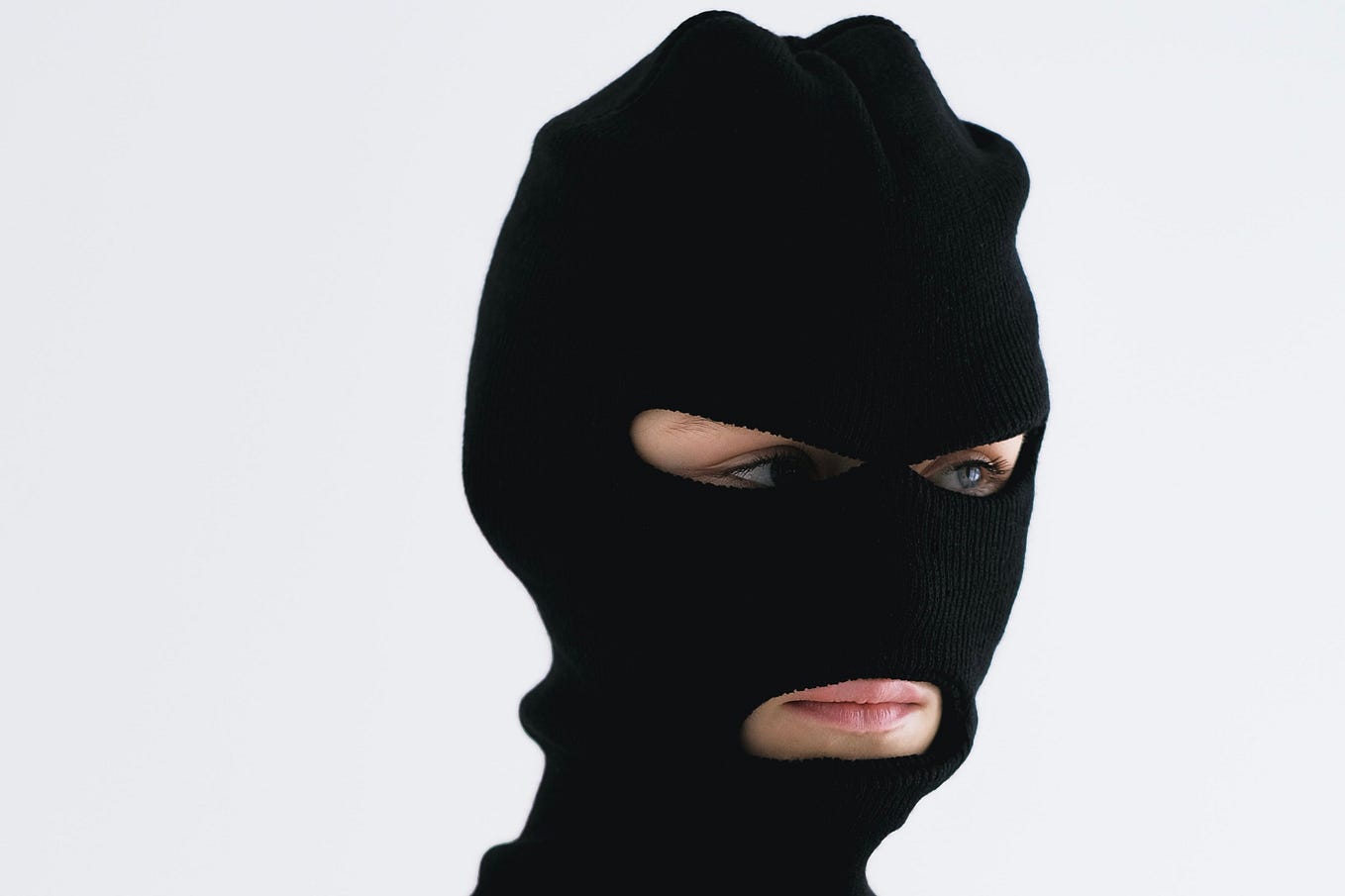 Close-up Shot of a Person Wearing a Robber Mask