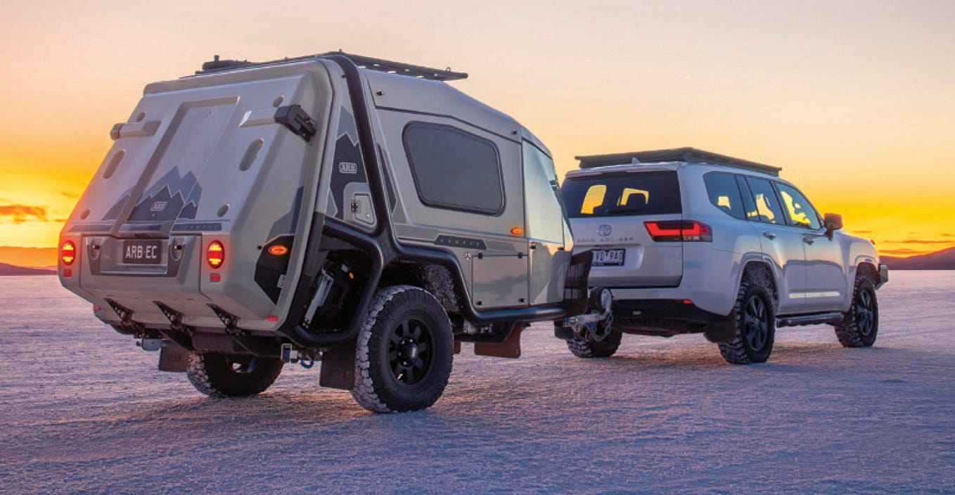 A closer look at the ARB Earth Camper as it is bing towed by an SUV