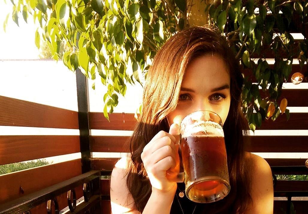 Author enjoying a mug of beer on an outdoor restaurant patio