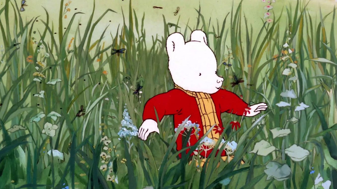 A still from “Rupert and the Frog Song”, showing Rupert trekking through a field.