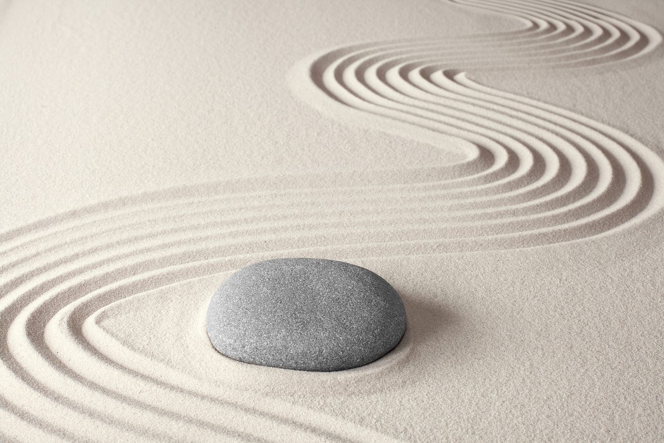 Picture of a single rock in a sand zen garden