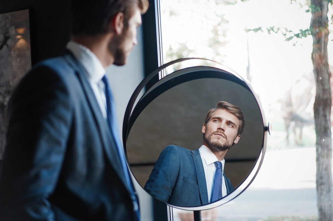 Business owner looking in the mirror — mirroring target audience.