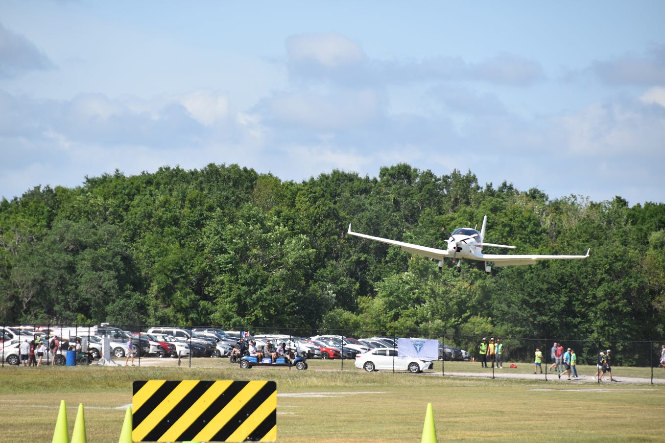 Photo of an airplane landing at Oshkosh.