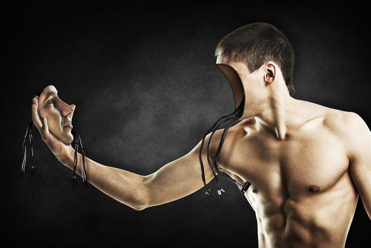 A naked man with a hole on his face holding that face in front of him, disconnected from several wires