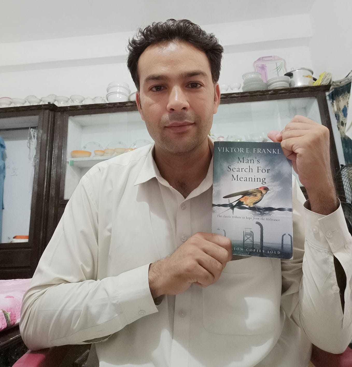 The Author is Holding the Book “Man’s Search For Meaning” in his hands