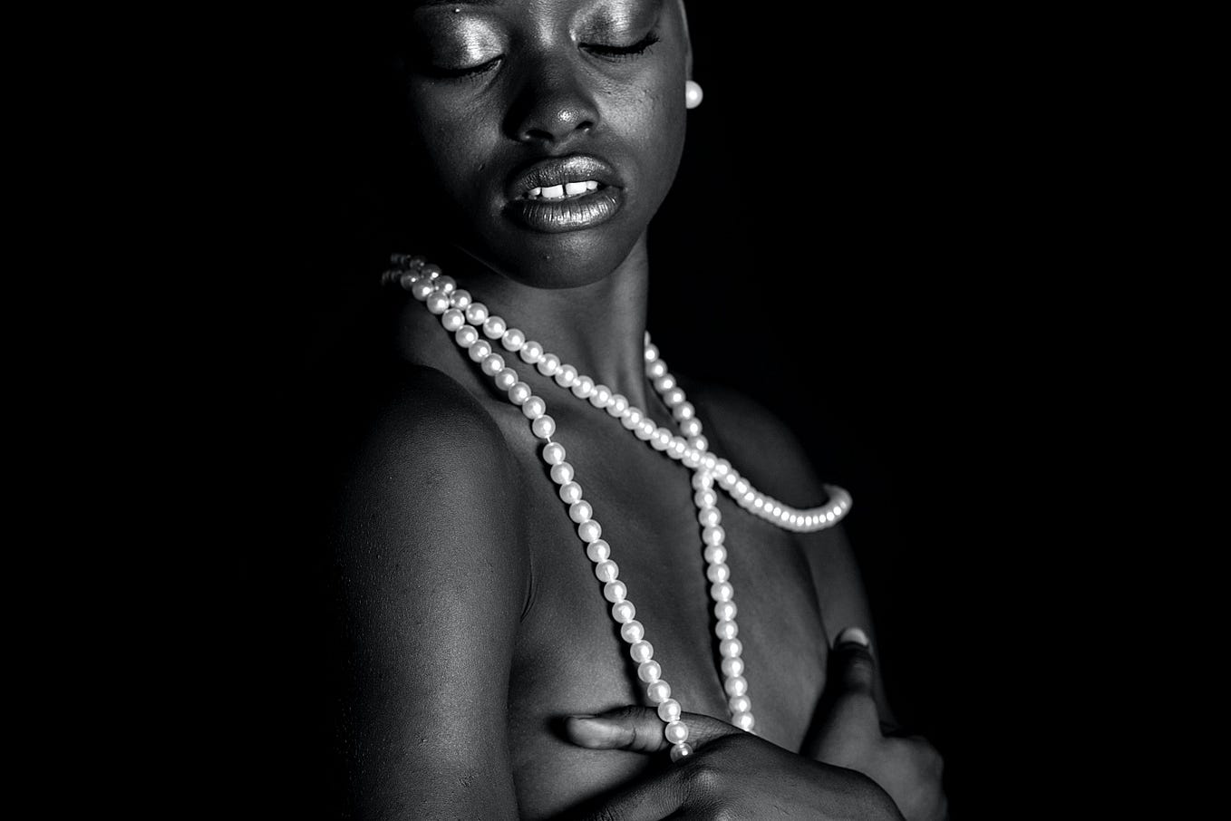 A beautiful woman of colour wearing pearls