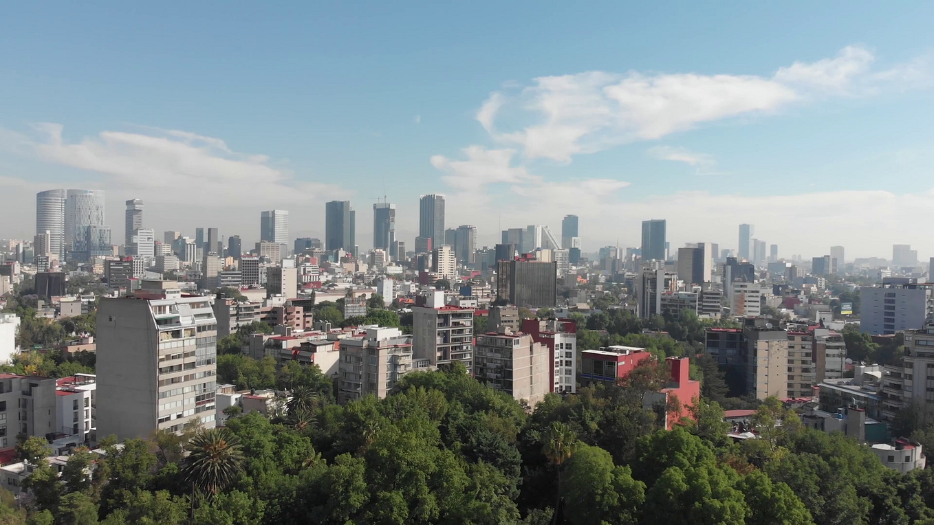 Aerial view of the Skyline in Mexico City, flying over Parque México