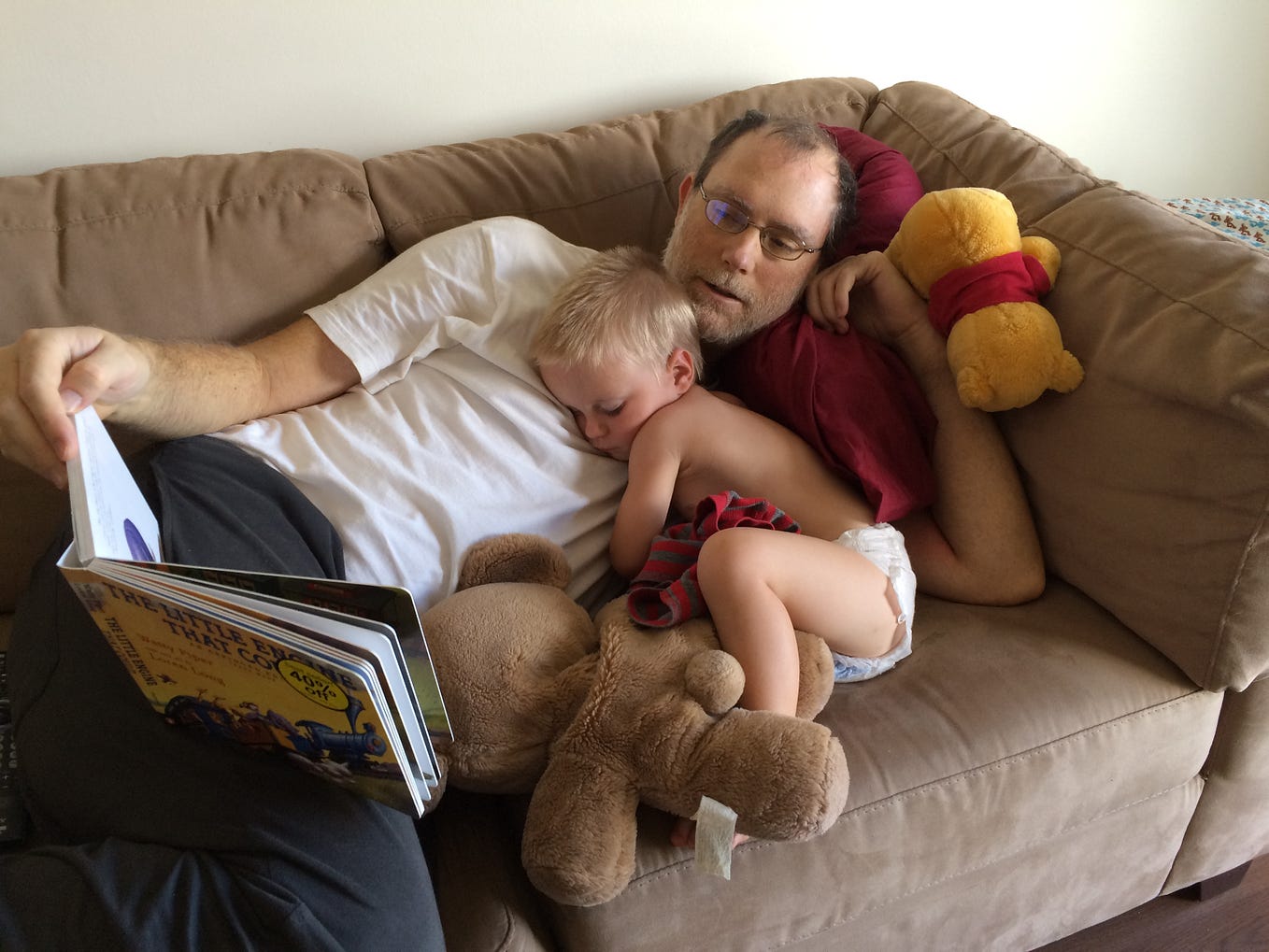 A dad reads to his toddler son.