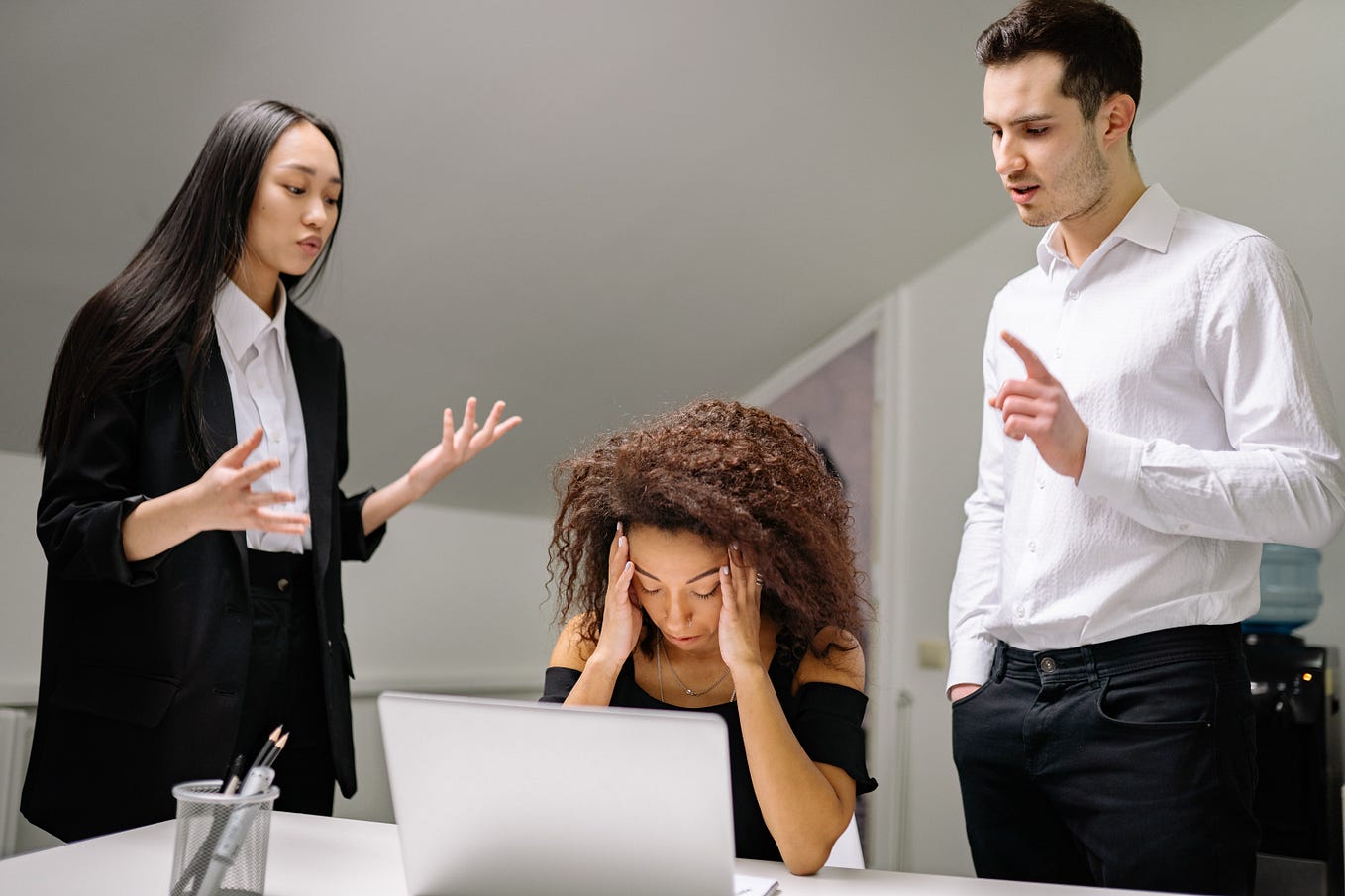 Two Managers scolding an employee at work.
