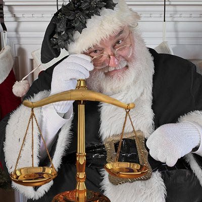 A picture of Emoluments Claus, a Santa Claus figure wearing all black robes holding the scales of justice.