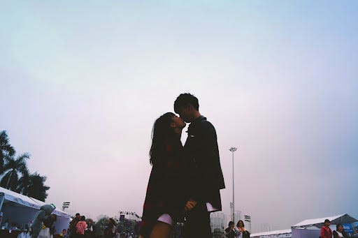 couple kissing together