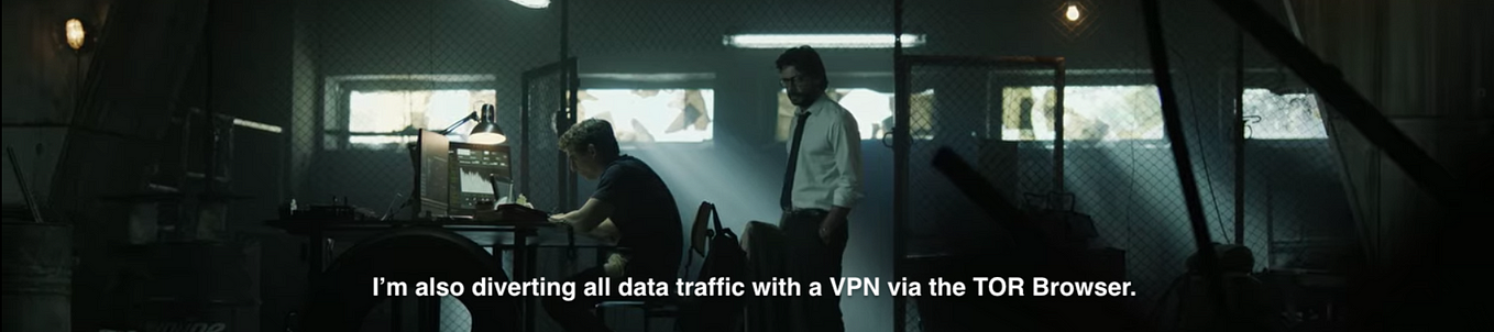 A hacker sits in a dark room in front of several screen showing technical information. The hacker explains to the old person behind them how they are accessing the darknet, i.e., by using a VPN to connect to the Tor browser.