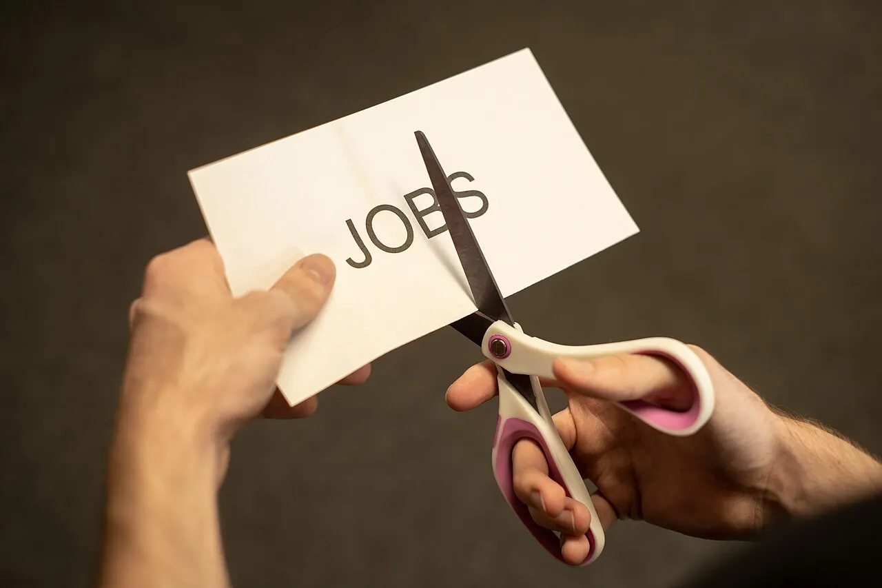 The word JOB being cut in two by scissors