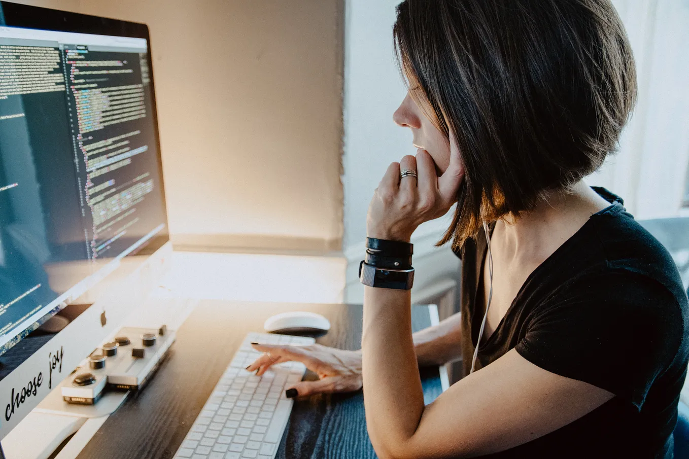 girl is sitting on the table using computer