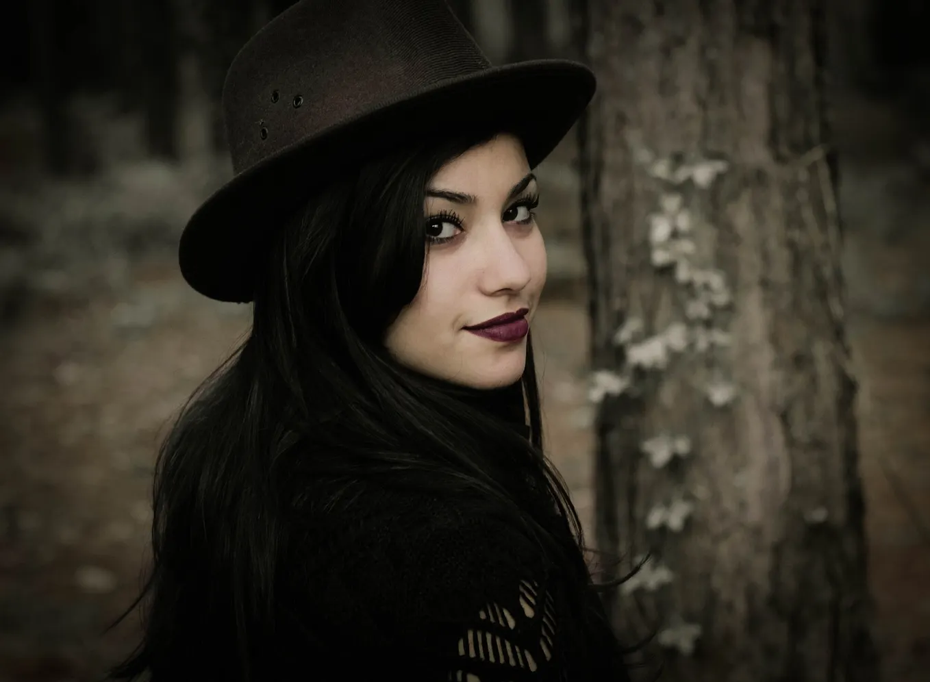 Image of a woman looking back in the woods
