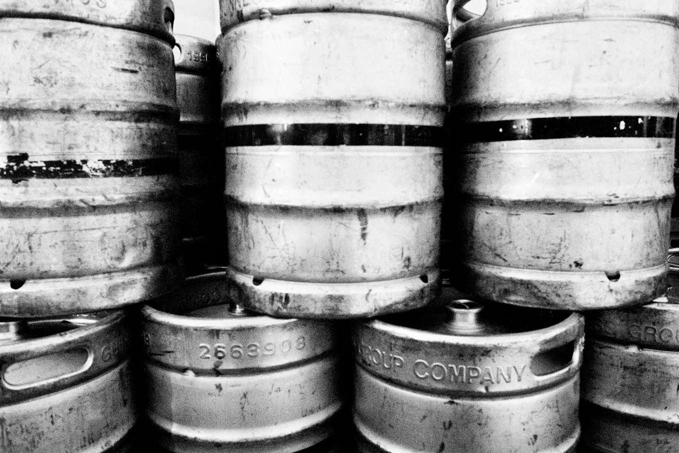 Piled up beer kegs.