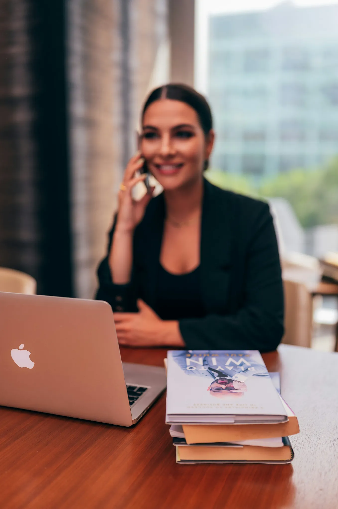 woman on a phone sitting at a desk