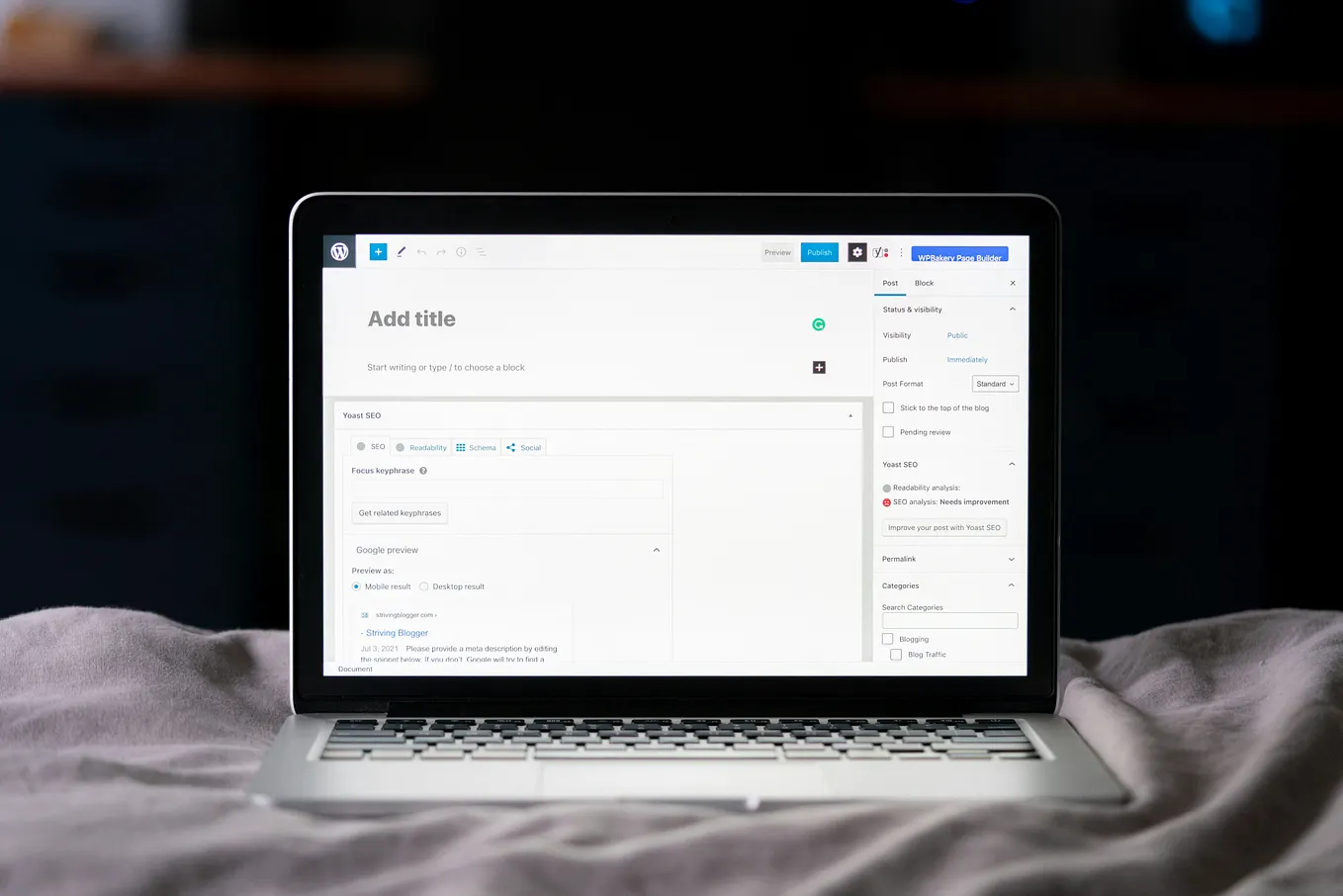 WordPress add a new post screen, with a laptop on the bed. 
