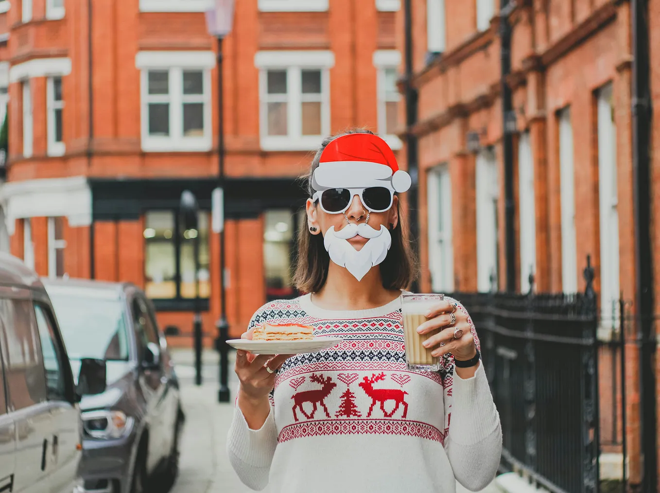 woman wearing a funny santa mask holding a plate of cookies and glass of milk