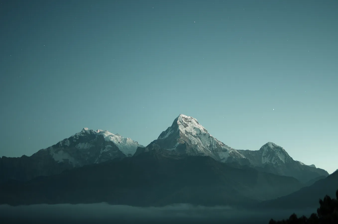 A mountain in the middle of a vast sky