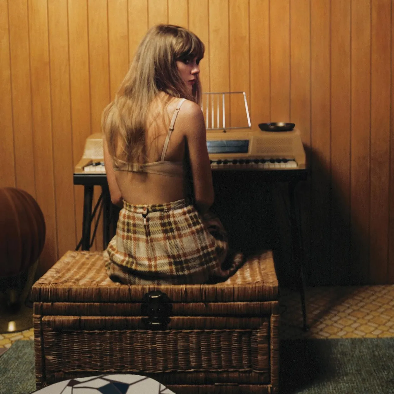 Taylor Swift playing a piano — promotional image