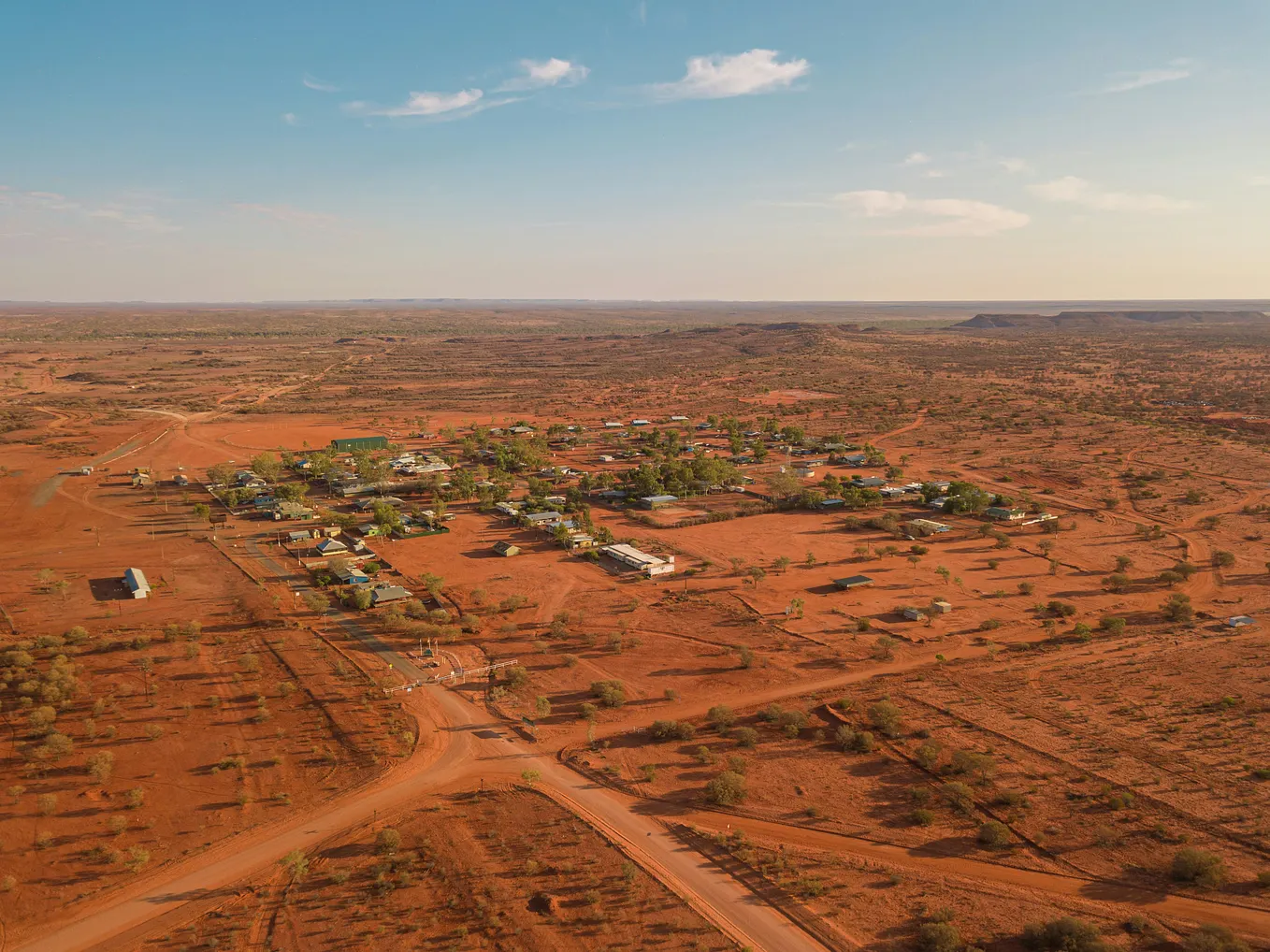 Unmade dirt roads and red earth as far as the eye can see, dotted with scrubby bushes, characterize this isolated Australian Outback township