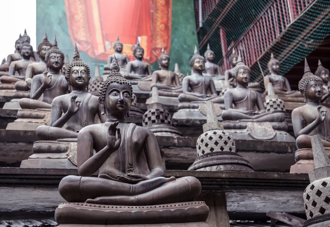 staircase with over a dozen bronze Buddha statues in various poses.