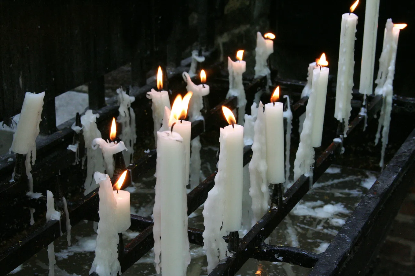 Picture of lit candles in a row.