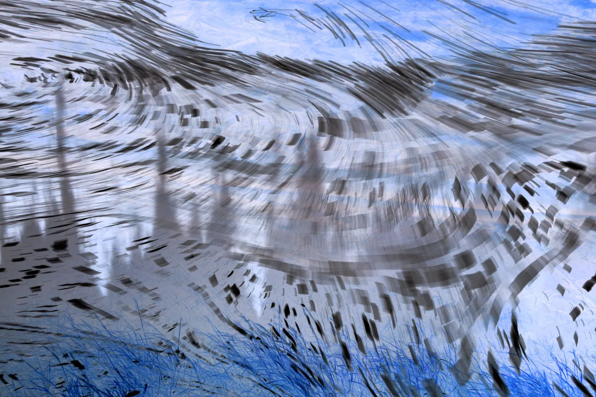 An abstract image of swirling patterns of blue and black.