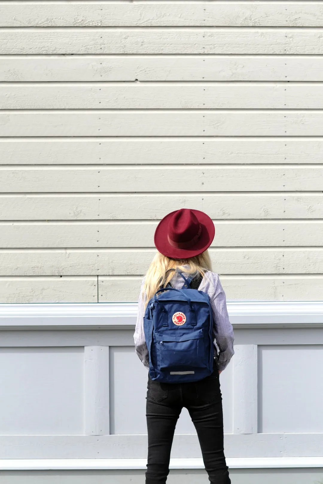 woman standing in front of wooden wall