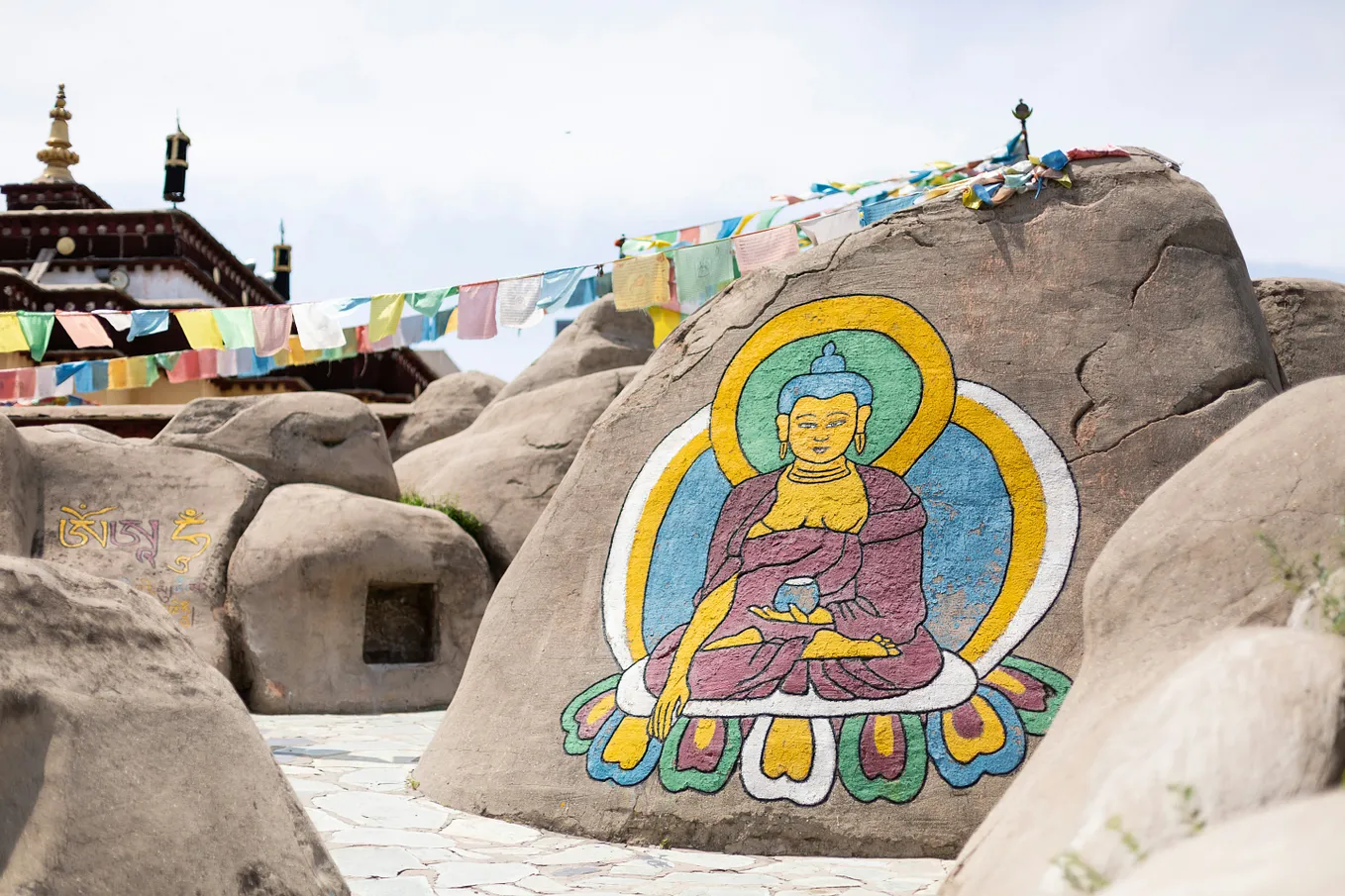 buddha’s painting on a rock