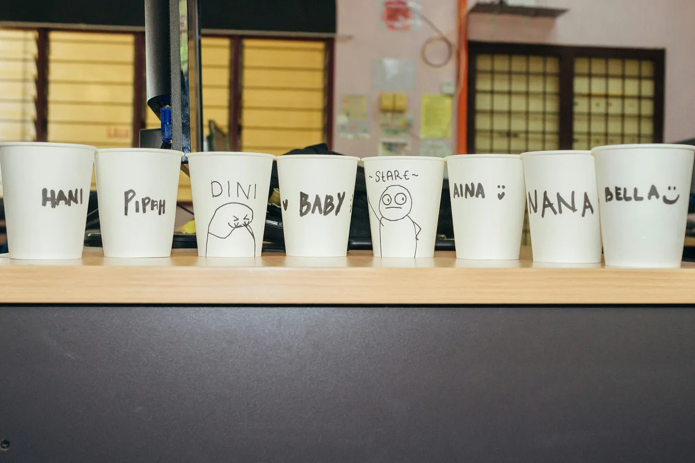 A row of paper cups with names written on them