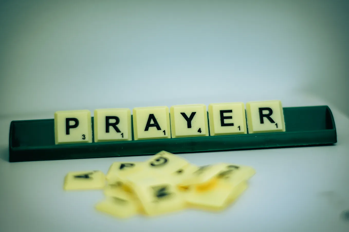 Prayer spelled out with Scrabble blocks.