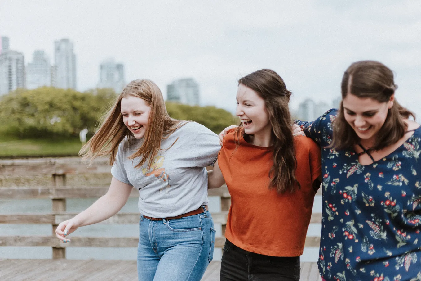 Three women friends laughing and walking