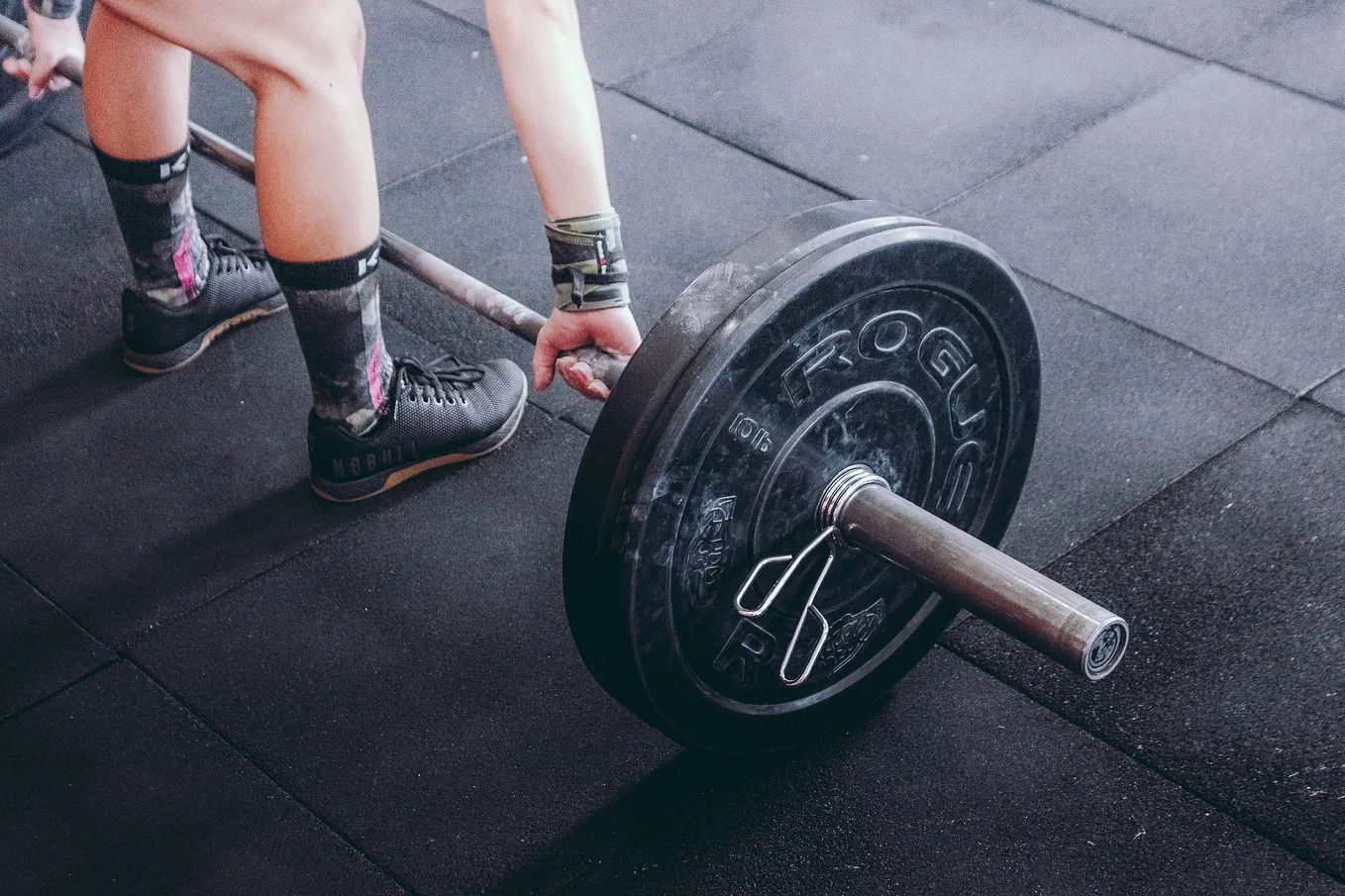 A man practices lifting in gym