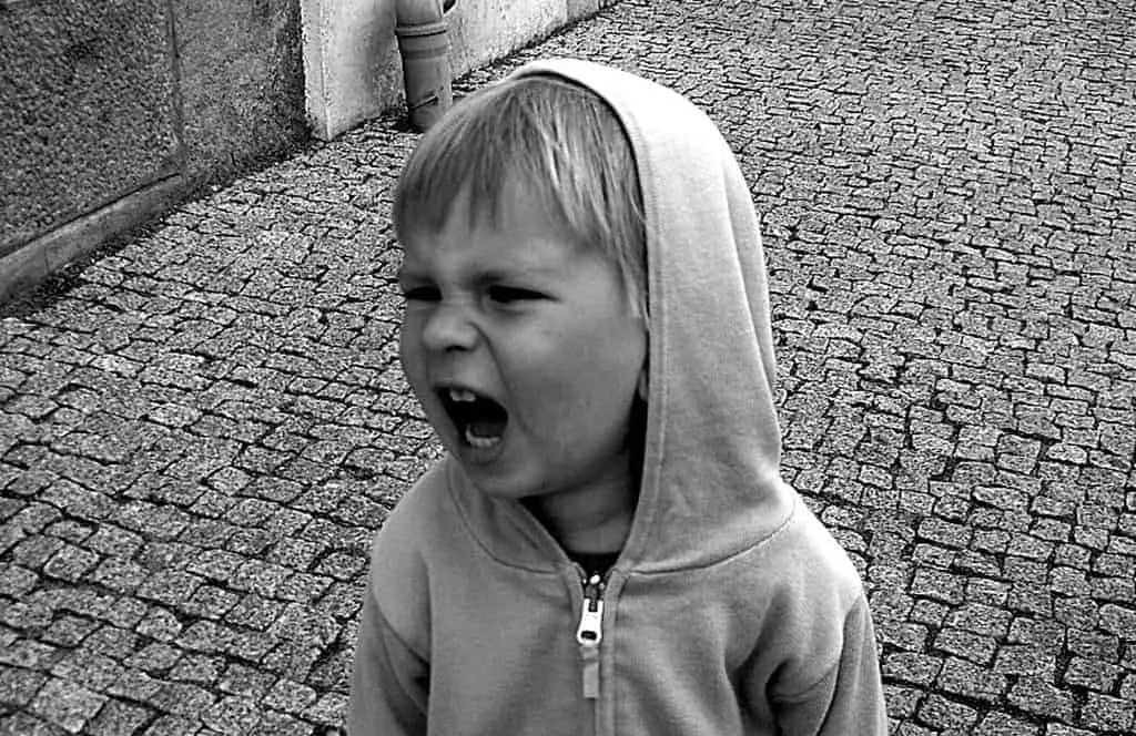 black and white photo of a frustrated boy