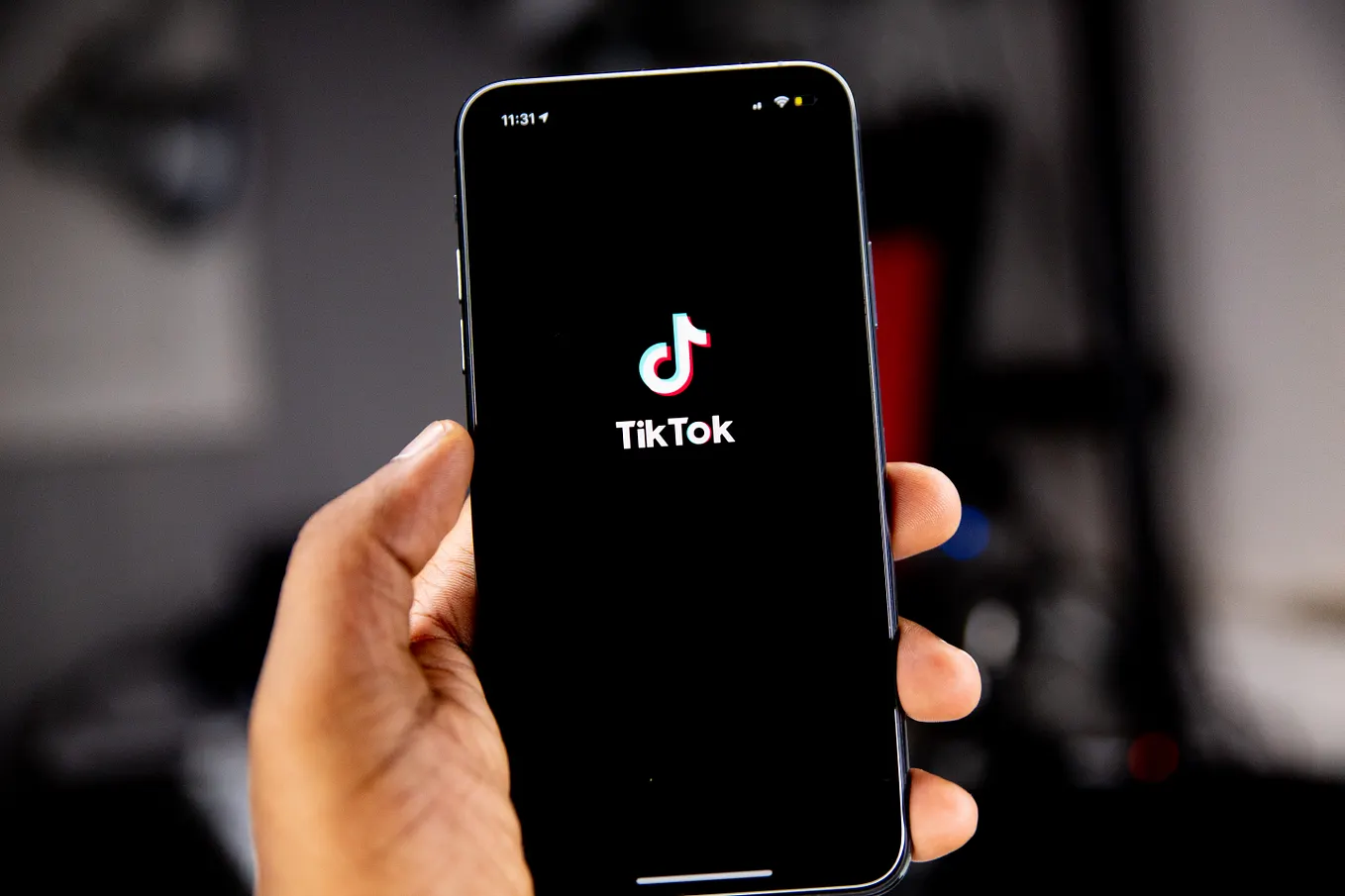 mobile phone with the TIKTOK symbol on a black background