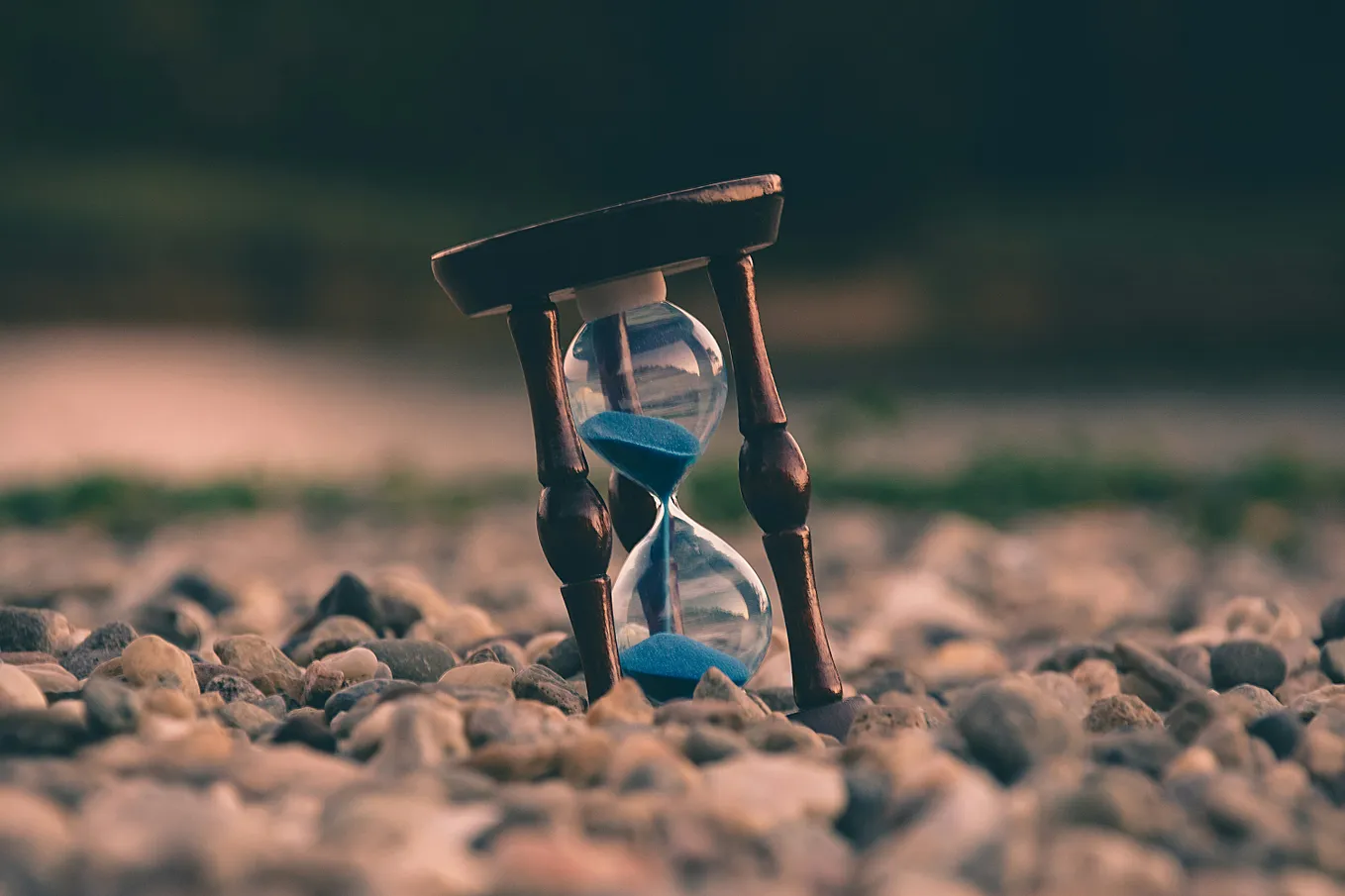 An hourglass stuck in a rocky base