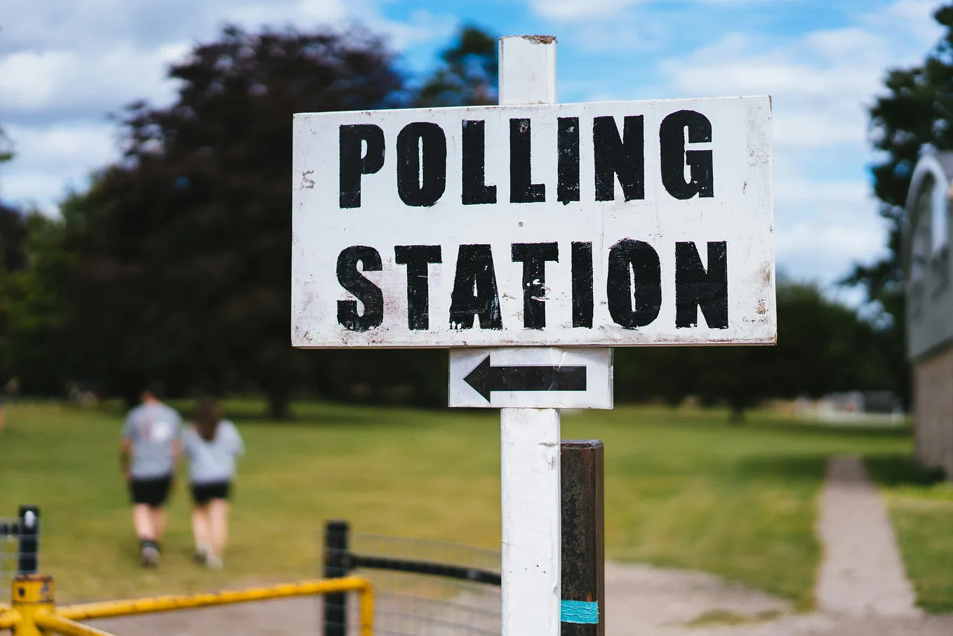 The writer pictures a sign showing an arrow pointing to a polling station.