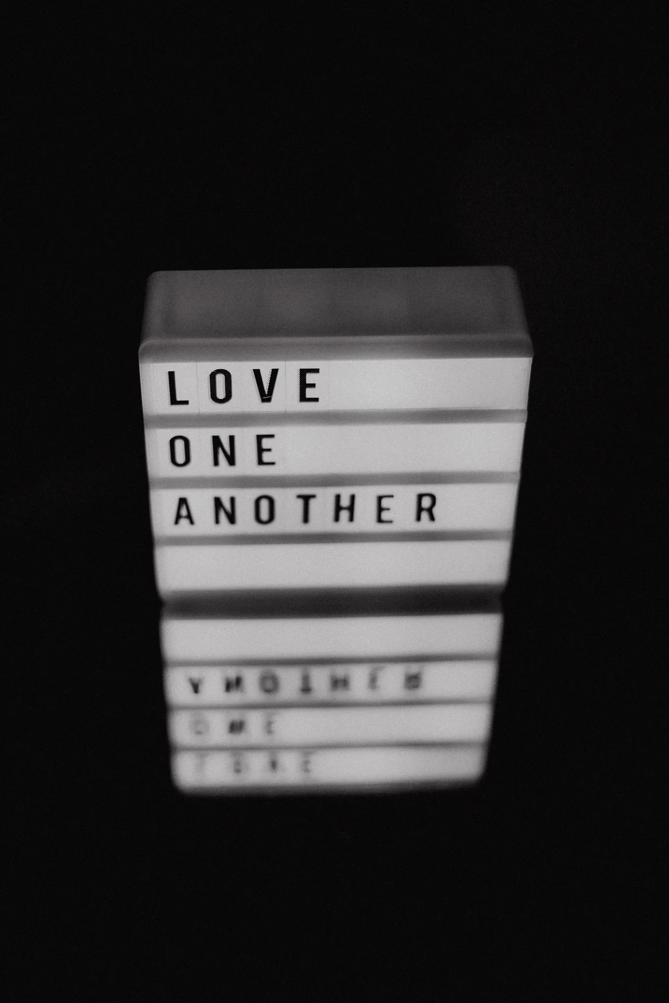 A digital sign bearing the words “Love one another”.